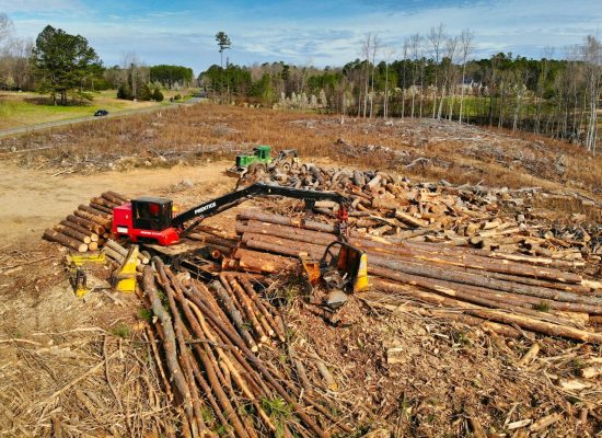 red and black heavy equipment on brown soil