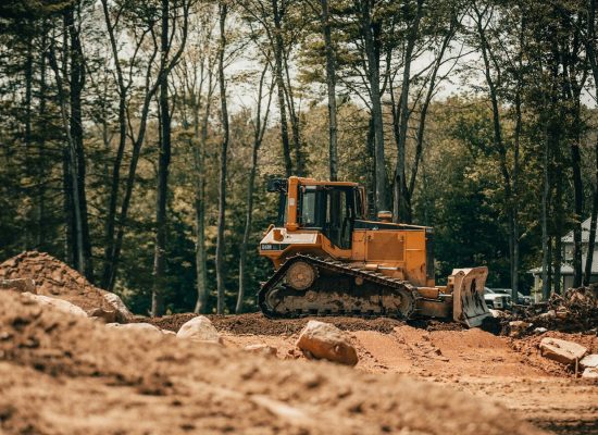 yellow and black heavy equipment on brown soil