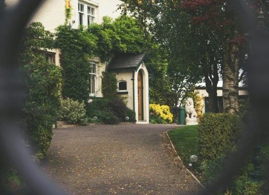minimalist photography of house shot in front of chain fence